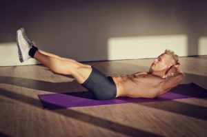 24285563 - attractive blond young man shirtless in gym working out, doing exercises for abs